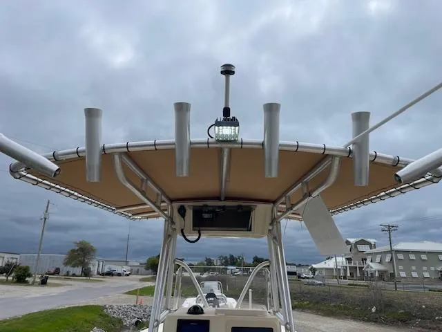 Slide: The Image of Parker 21 SE boat, 2013 model, featuring a T-top with rod holders and navigation light. - 15