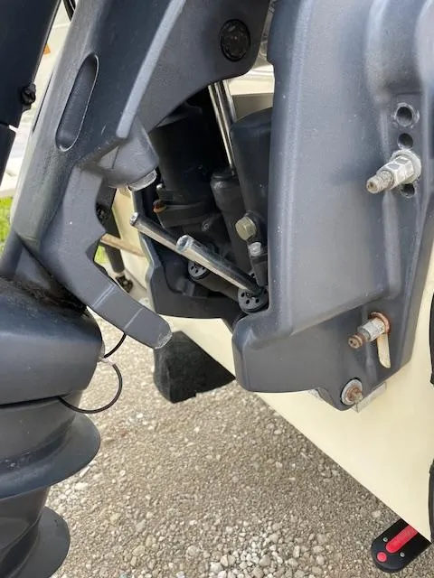 Slide: The Image of Close-up of a 2013 Parker 21 SE boat engine component with visible bolts and mechanisms. - 22