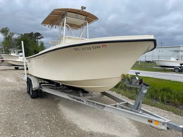 Slide: The Image of Parker 21 SE boat on trailer, 2013 model, parked outdoors under cloudy sky. - 4