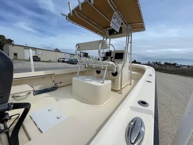 Slide: The Image of 2013 Parker 21 SE boat with canopy and seating, parked outdoors. - 6