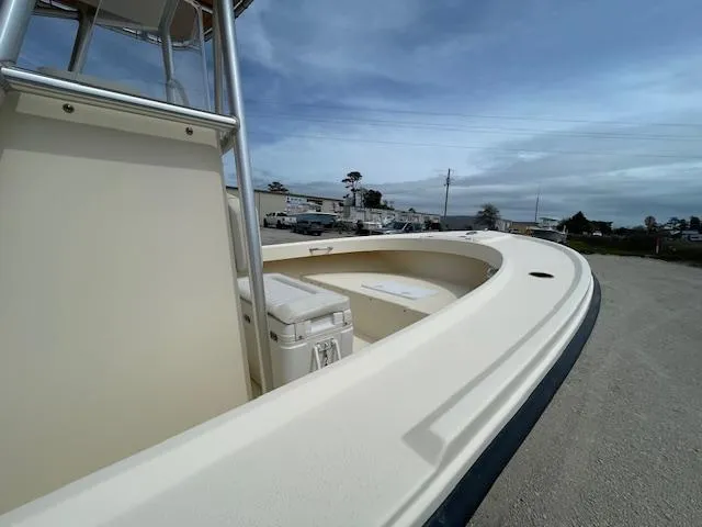 Slide: The Image of 2013 Parker 21 SE boat with spacious deck and clear sky background. - 7