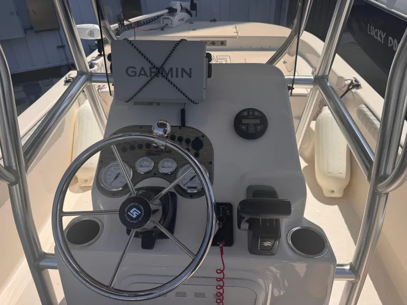 Slide: The Image of 2024 Carolina Skiff 21 LS boat console with Garmin navigation system and steering wheel. - 12