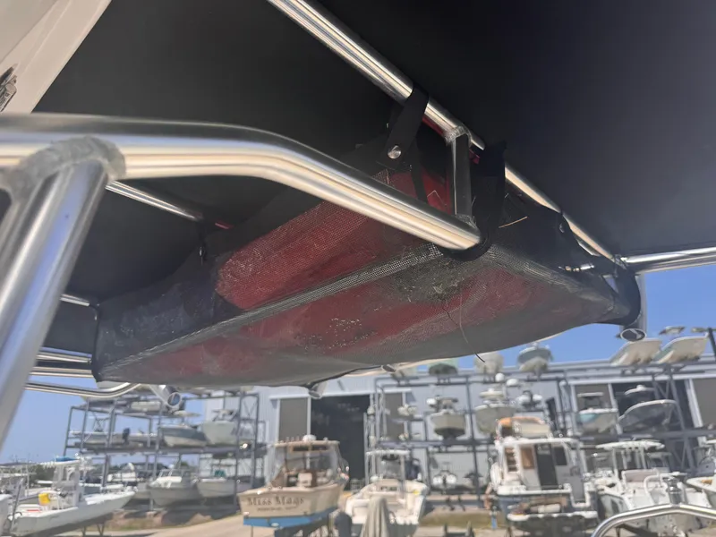 Slide: The Image of 2024 Carolina Skiff 21 LS boat with overhead storage, marina background. - 14