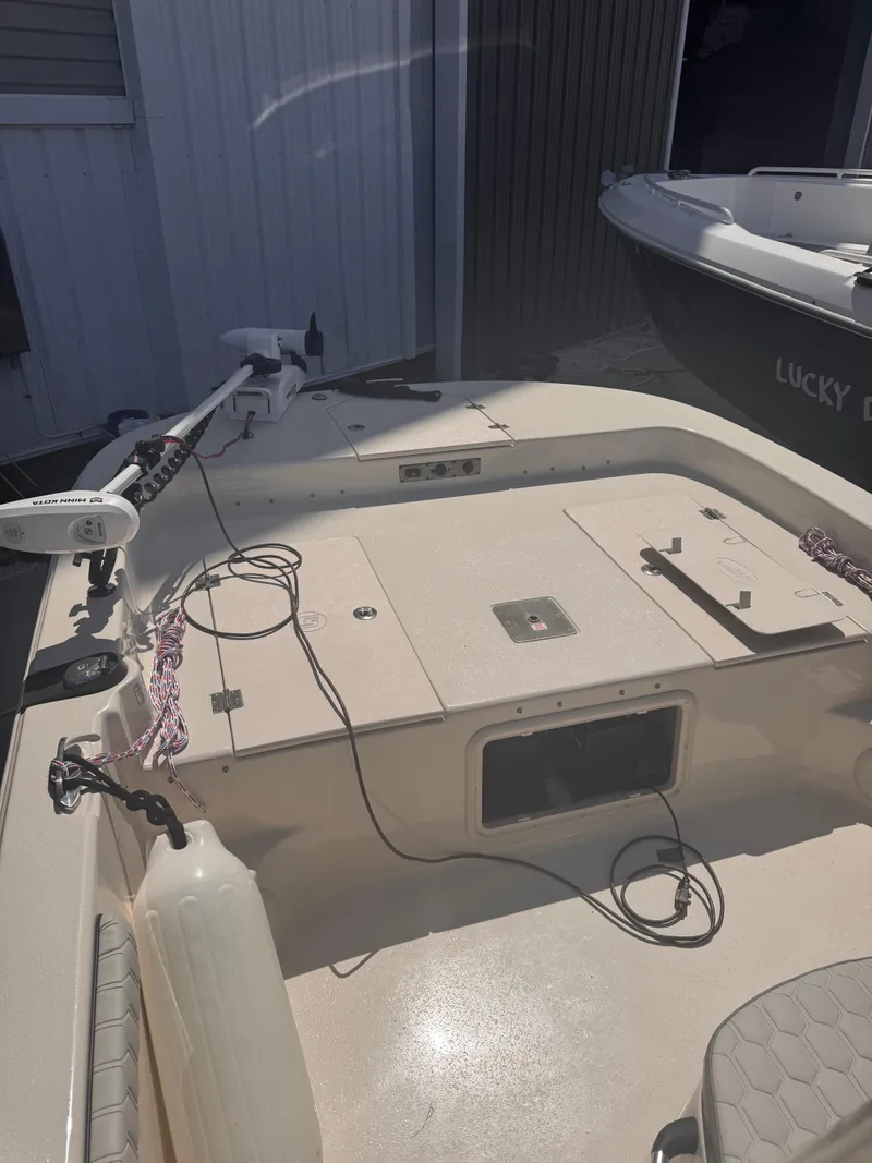 Slide: The Image of 2024 Carolina Skiff 21 LS boat interior with equipment and storage compartments. - 3