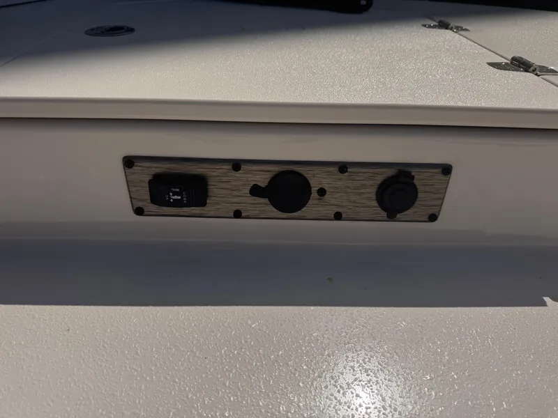 Slide: The Image of Control panel on 2024 Carolina Skiff 21 LS boat, featuring switches and outlets. - 6