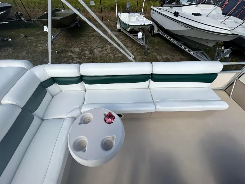 Slide: The Image of 2004 Godfrey Tuscany 220 pontoon boat interior with white seating and cup holders. - 10
