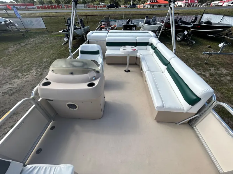 Slide: The Image of 2004 Godfrey Tuscany 220 pontoon boat interior with spacious seating and helm. - 6