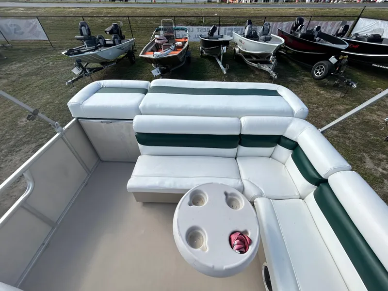Slide: The Image of 2004 Godfrey Tuscany 220 pontoon boat interior with seating and cup holders. - 7