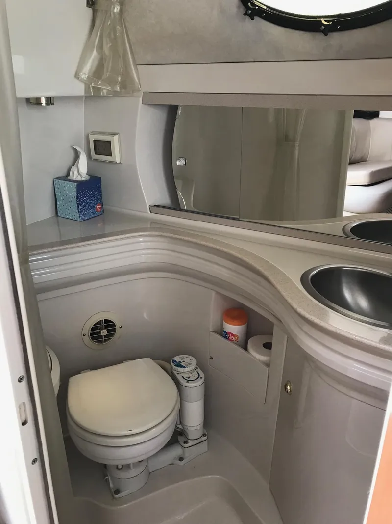 Slide: The Image of Bathroom interior of 1999 Regal 292 Commodore boat with sink and toilet. - 17