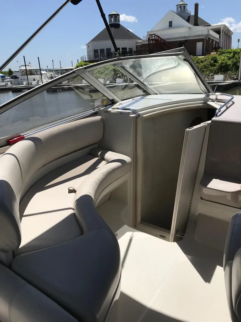 Slide: The Image of 1999 Regal 292 Commodore boat interior with seating and open cabin door. - 7