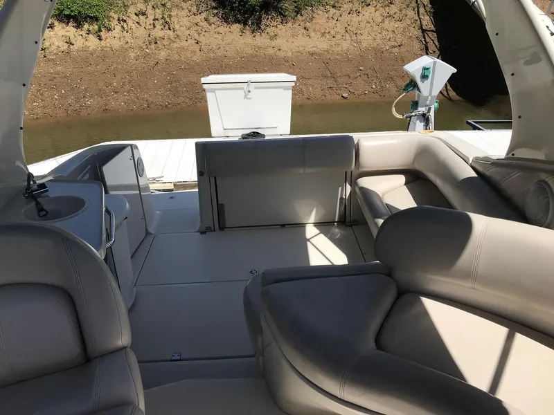 Slide: The Image of 1999 Regal 292 Commodore boat interior with beige seating and open deck. - 8