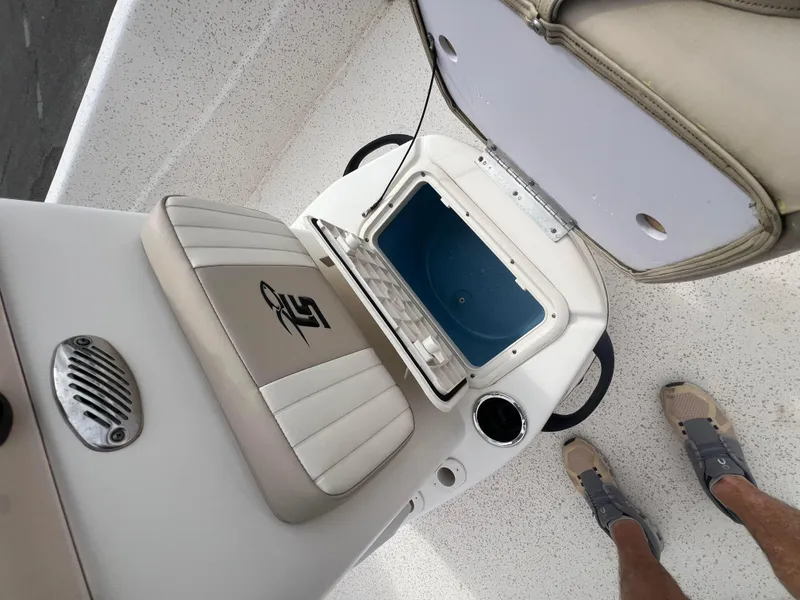 Slide: The Image of 2019 Carolina Skiff 218 DLV boat interior with open storage compartment and seating. - 10