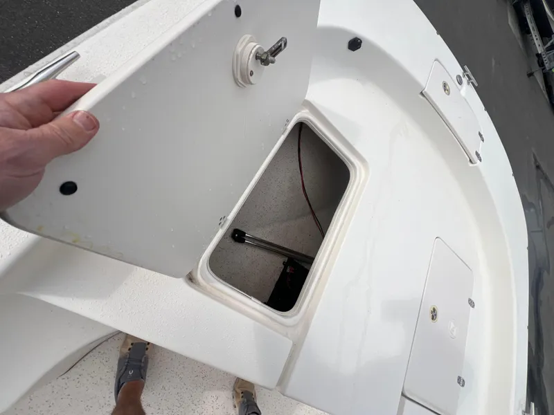 Slide: The Image of 2019 Carolina Skiff 218 DLV boat storage compartment open on deck. - 11