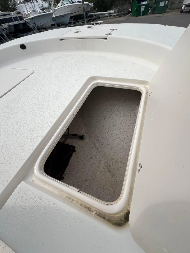 Slide: The Image of 2019 Carolina Skiff 218 DLV boat storage compartment, open and empty. - 12