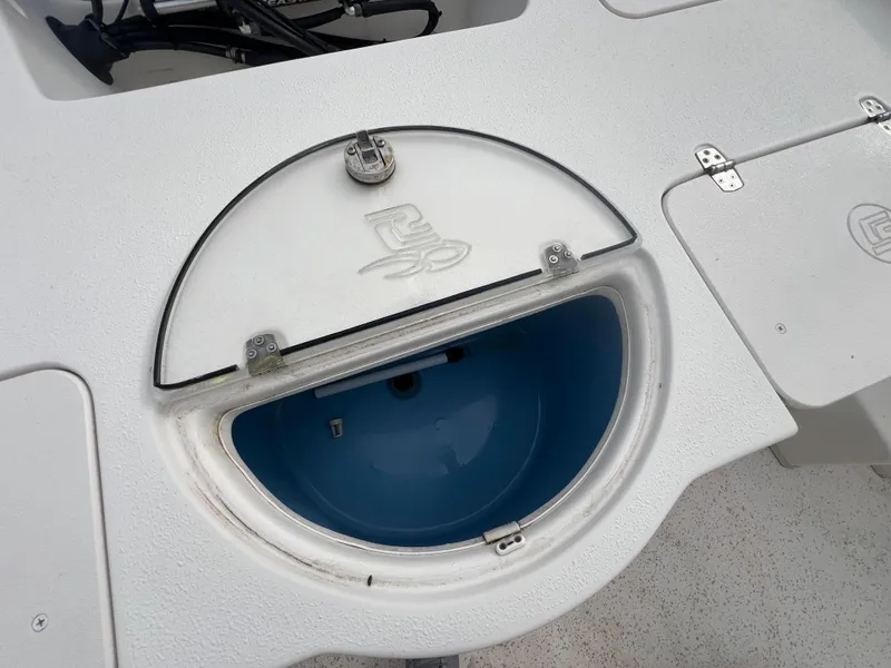 Slide: The Image of 2019 Carolina Skiff 218 DLV boat with open circular storage compartment. - 6