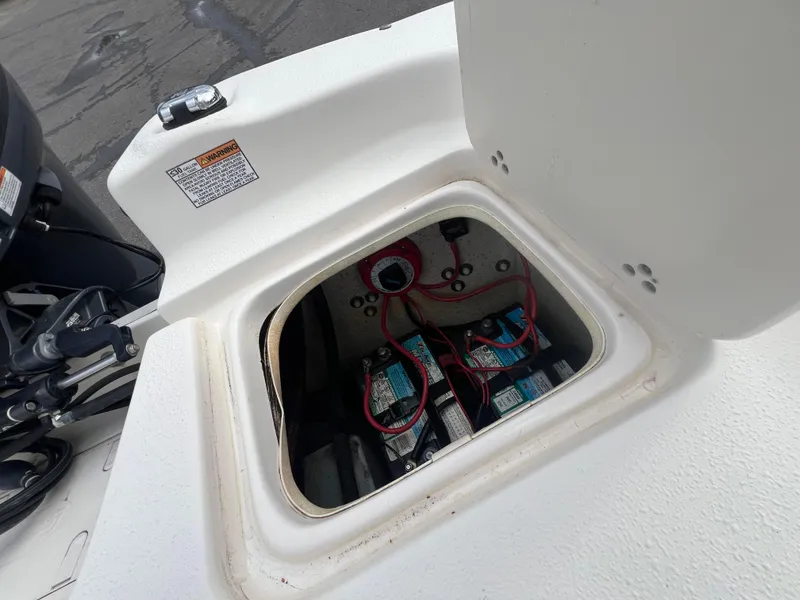 Slide: The Image of Battery compartment of a 2019 Carolina Skiff 218 DLV boat, showing wiring and connections. - 8