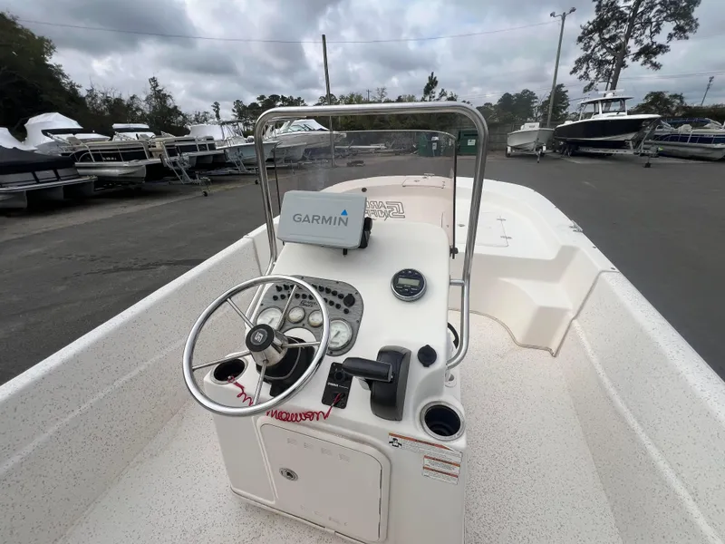Slide: The Image of 2019 Carolina Skiff 218 DLV boat with Garmin navigation, parked in a marina. - 9