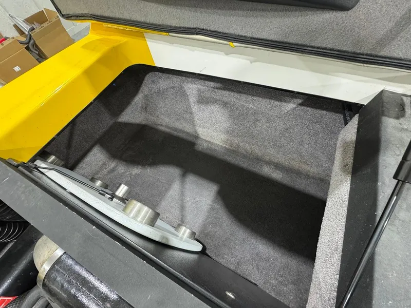 Slide: The Image of Storage compartment of a 2007 Malibu Sunscape 23 LSV boat, featuring a clean, carpeted interior. - 18
