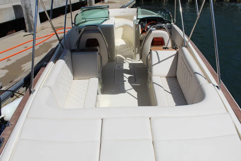 Slide: The Image of 2022 Chris-Craft Launch 27 boat interior with white seating and elegant design. - 2