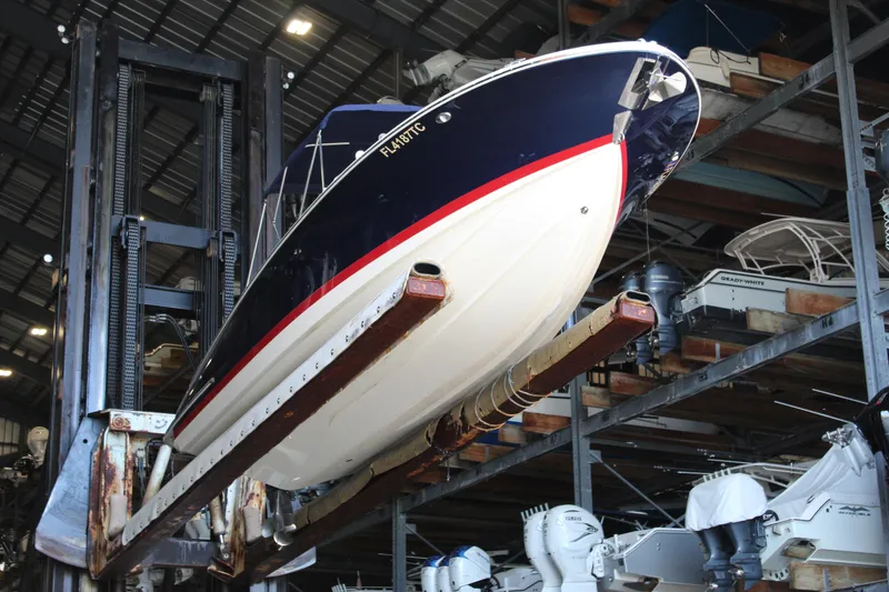 Slide: The Image of 2022 Chris-Craft Launch 27 boat in storage, elevated on a rack indoors. - 32