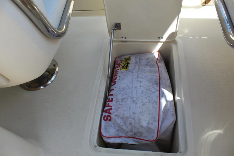 Slide: The Image of 2022 Chris-Craft Launch 27 storage compartment with safety gear bag inside. - 36