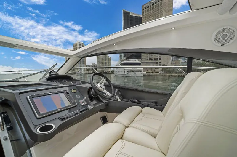 Slide: The Image of Interior of 2016 Princess V39 yacht with modern dashboard and city skyline view. - 11