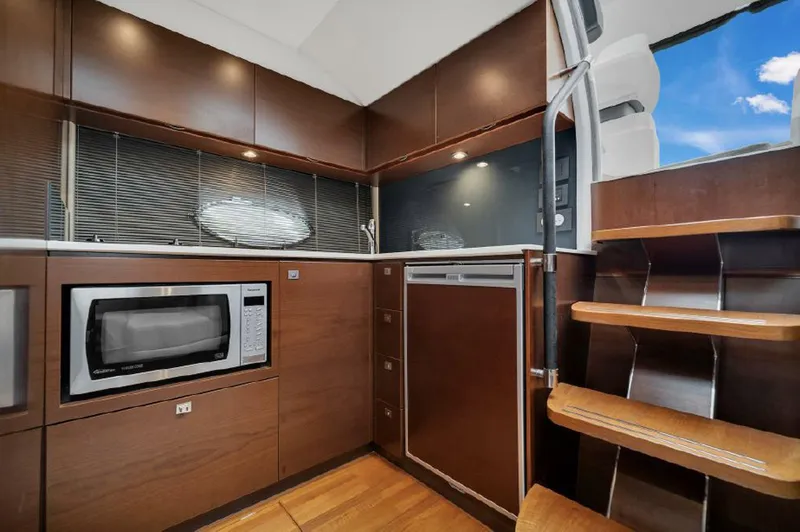 Slide: The Image of Modern kitchen interior of 2016 Princess V39 yacht with wood cabinetry and stainless steel appliances. - 17