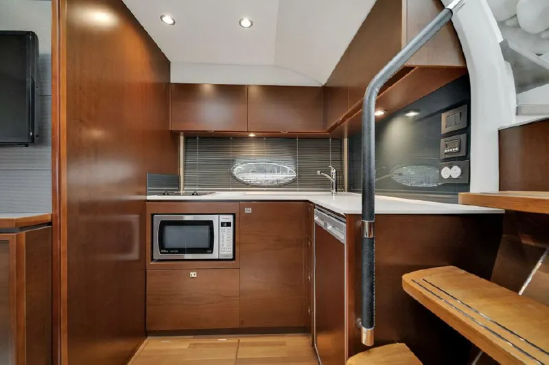Slide: The Image of Luxurious 2016 Princess V39 yacht interior with modern kitchen and wooden cabinetry. - 18