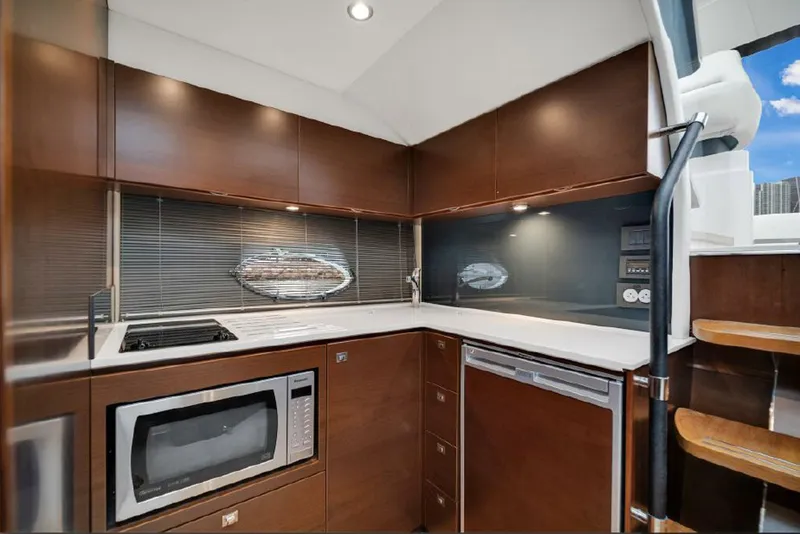 Slide: The Image of Luxurious 2016 Princess V39 yacht kitchen with modern appliances and sleek wood cabinetry. - 19