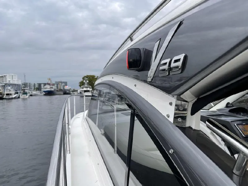 Slide: The Image of 2016 Princess V39 yacht docked in a marina, showcasing sleek design and modern features. - 2