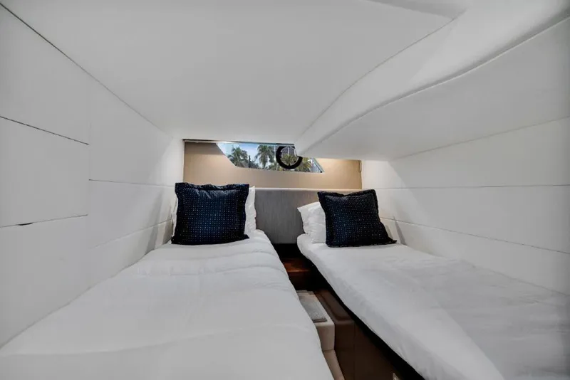 Slide: The Image of Twin cabin interior of 2016 Princess V39 yacht with white bedding and blue cushions. - 24