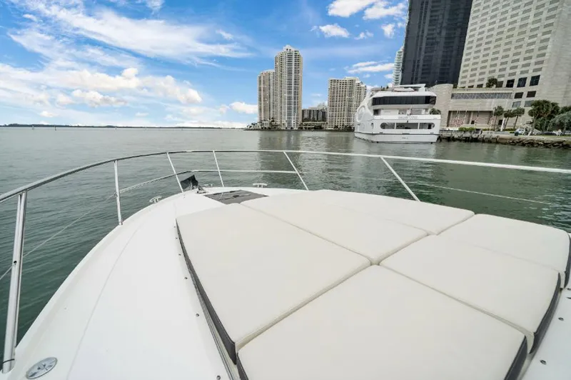 Slide: The Image of 2016 Princess V39 yacht cruising near city skyline and waterfront buildings. - 27