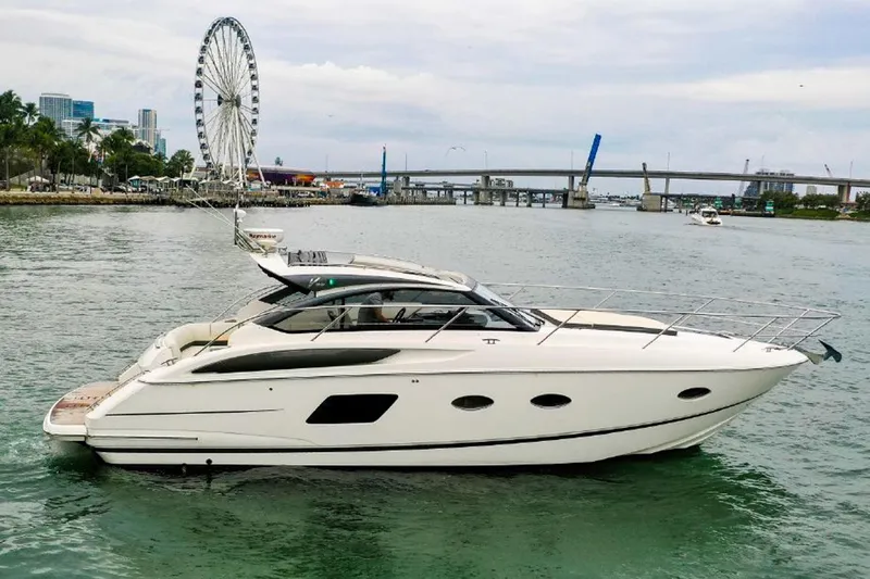 Slide: The Image of 2016 Princess V39 yacht cruising near a city waterfront with a Ferris wheel. - 3