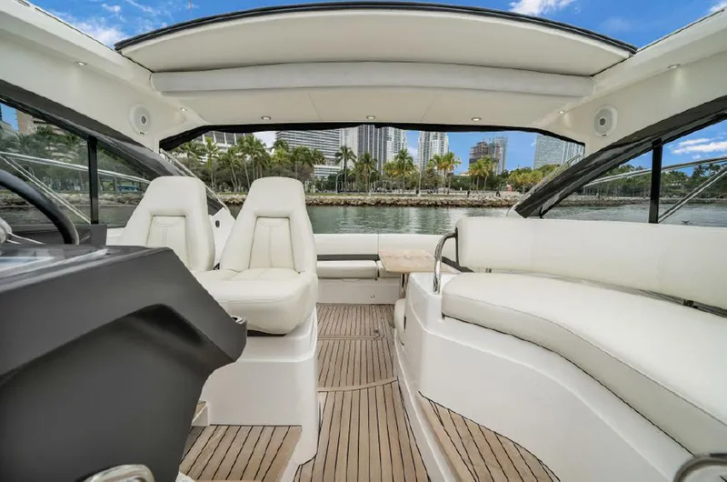 Slide: The Image of Luxurious 2016 Princess V39 yacht interior with white seating and scenic waterfront view. - 7