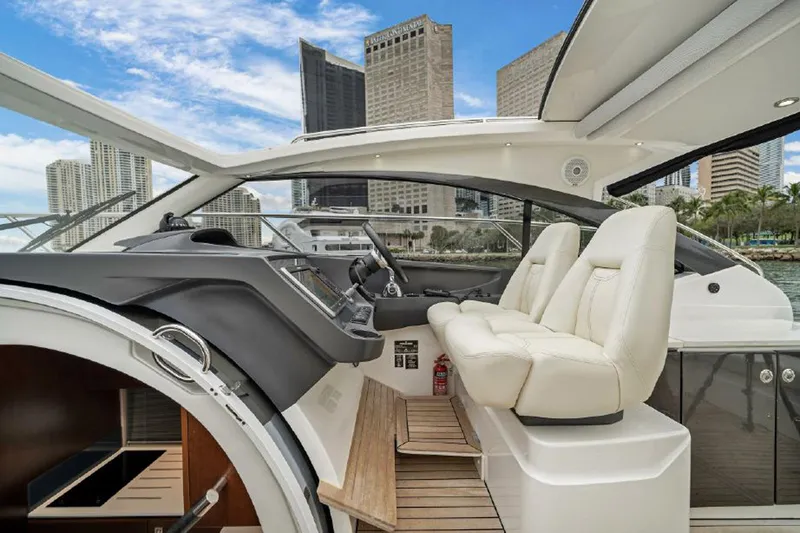 Slide: The Image of 2016 Princess V39 yacht interior with modern helm, white seats, and city skyline view. - 9