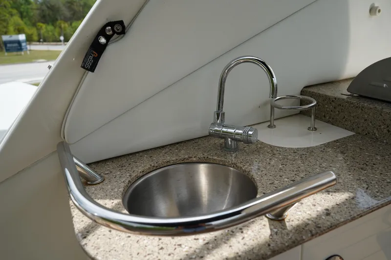 Slide: The Image of 2016 Sea Ray 330 Sundancer boat sink with stainless steel faucet and granite countertop. - 10