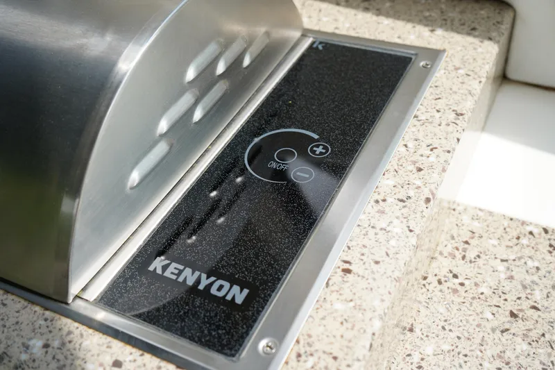 Slide: The Image of Kenyon grill on 2016 Sea Ray 330 Sundancer boat, featuring sleek design and modern controls. - 12