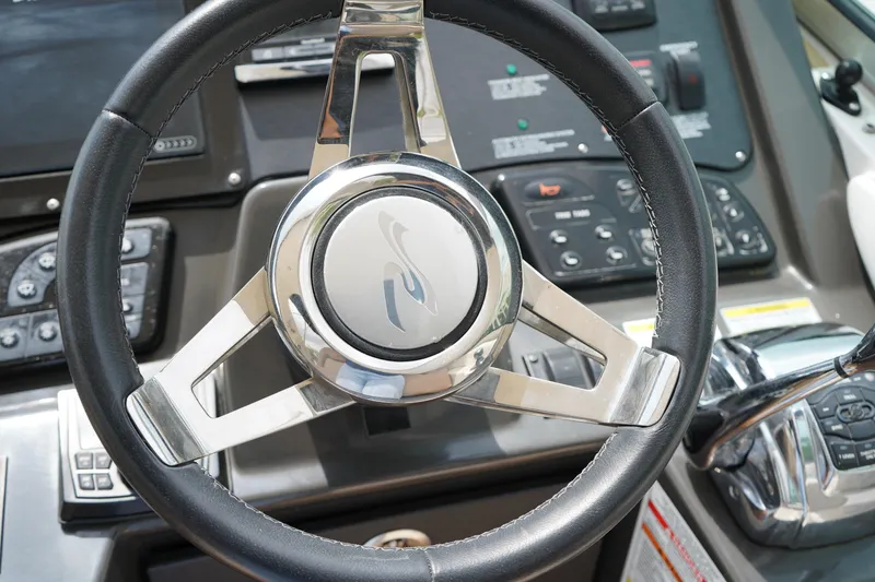 Slide: The Image of Steering wheel of 2016 Sea Ray 330 Sundancer boat, featuring modern controls and dashboard. - 16
