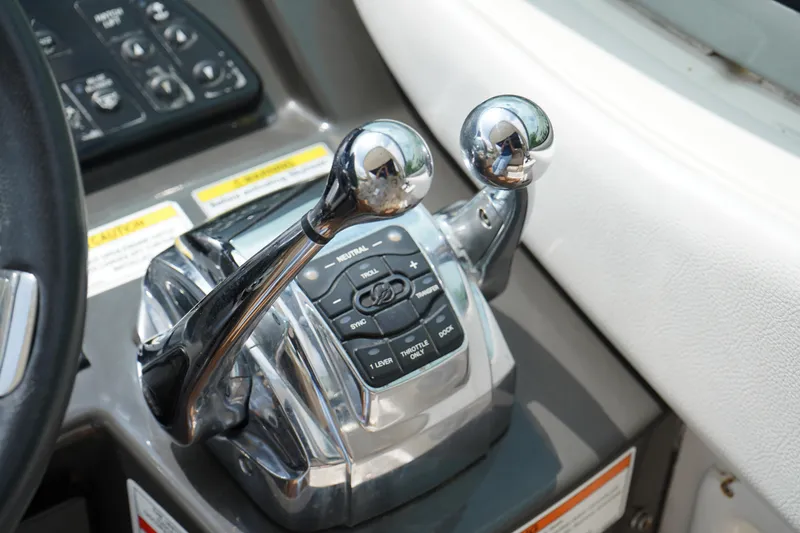 Slide: The Image of Control panel of a 2016 Sea Ray 330 Sundancer boat with dual throttle levers. - 17