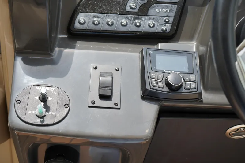 Slide: The Image of Control panel of a 2016 Sea Ray 330 Sundancer boat with navigation and light switches. - 18