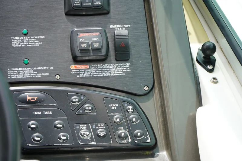 Slide: The Image of Control panel of a 2016 Sea Ray 330 Sundancer boat with various switches and indicators. - 23