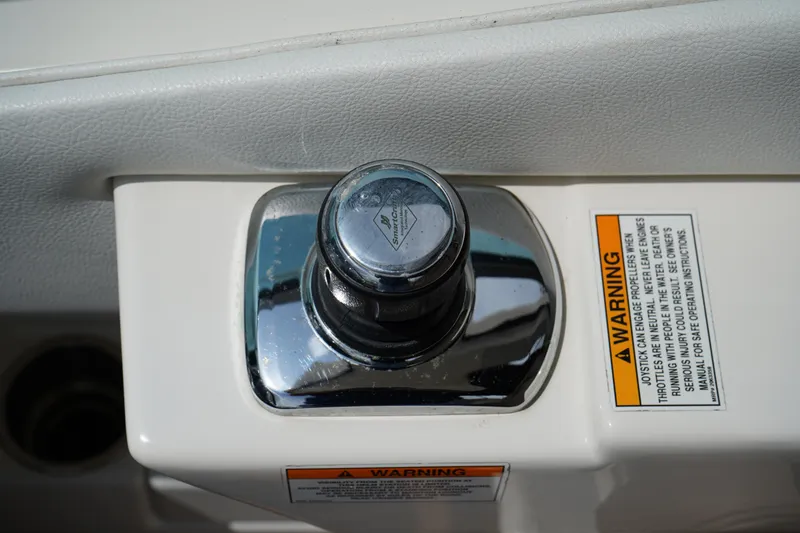 Slide: The Image of Control knob on 2016 Sea Ray 330 Sundancer boat with warning labels. - 24