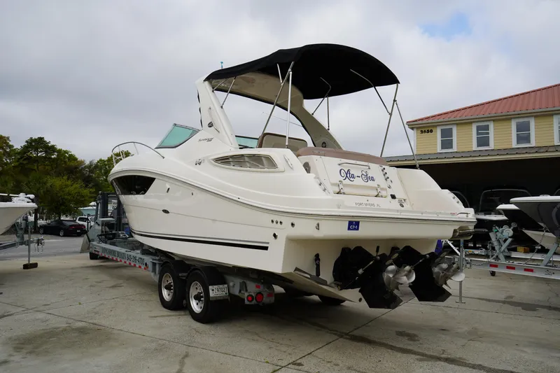 Slide: The Image of 2016 Sea Ray 330 Sundancer boat on trailer, parked outdoors near a building. - 3