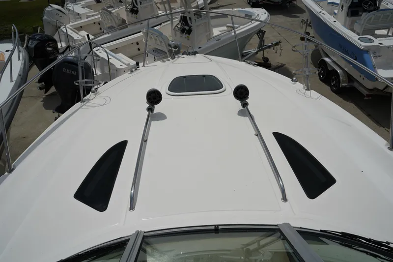 Slide: The Image of 2016 Sea Ray 330 Sundancer boat deck with railings and hatch. - 32