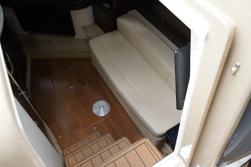 Slide: The Image of Interior cabin of 2016 Sea Ray 330 Sundancer with beige seating and wooden flooring. - 34