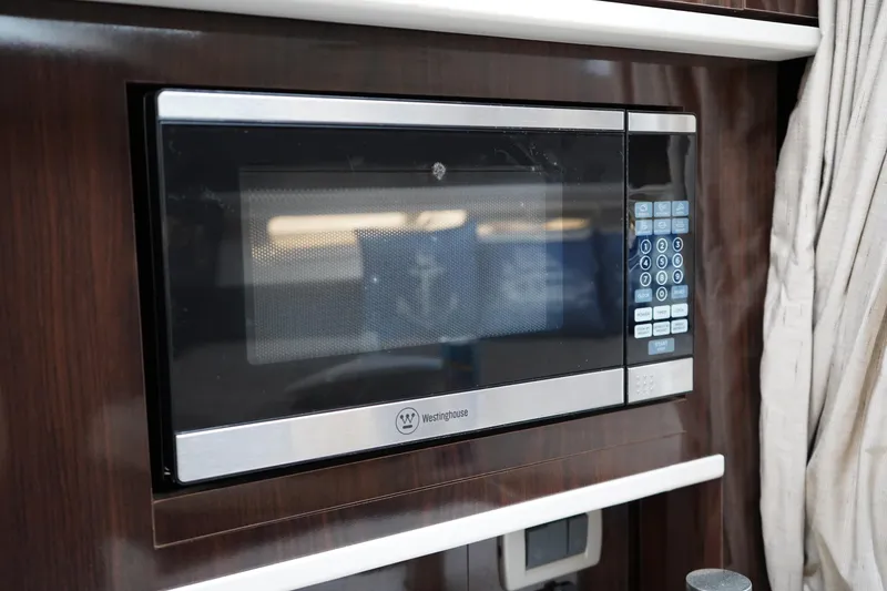 Slide: The Image of Microwave oven inside 2016 Sea Ray 330 Sundancer yacht kitchen area. - 37