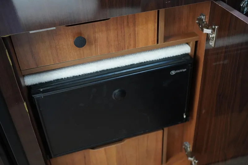 Slide: The Image of Wooden cabinet with a black appliance inside, Sea Ray 330 Sundancer 2016 model. - 43