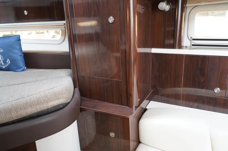 Slide: The Image of Interior of 2016 Sea Ray 330 Sundancer with wood paneling and seating. - 47