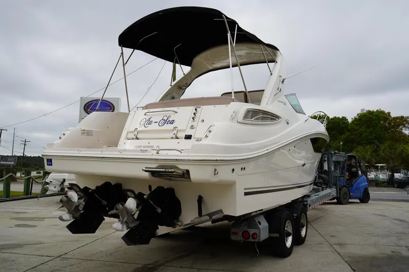 Slide: The Image of 2016 Sea Ray 330 Sundancer boat on trailer, rear view with dual propellers. - 6