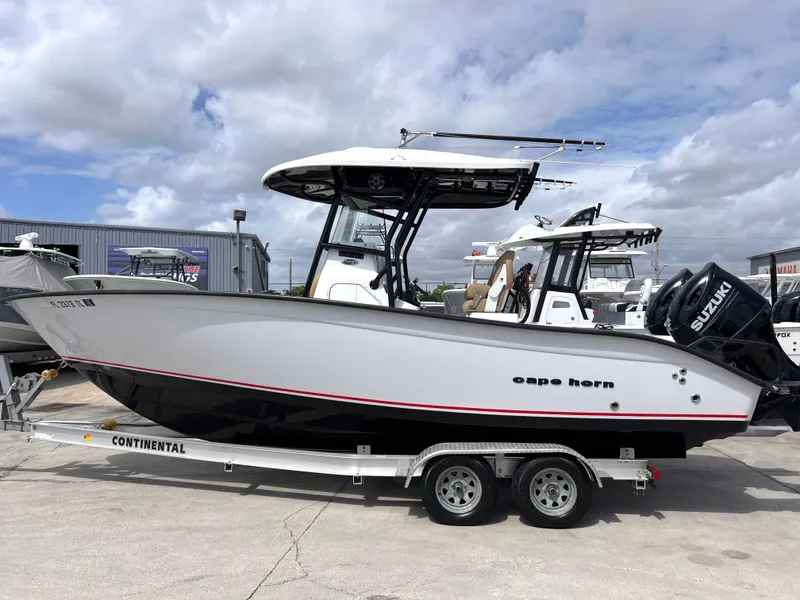 The Image of 2022 Cape Horn 24 XS boat on trailer, featuring sleek design and Suzuki outboard motor. - 0